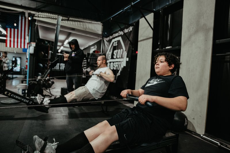 Father and son work out together at The Fit Stop