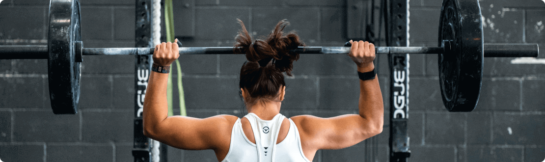 A Person Lifting weights PushPress Gym Management Software